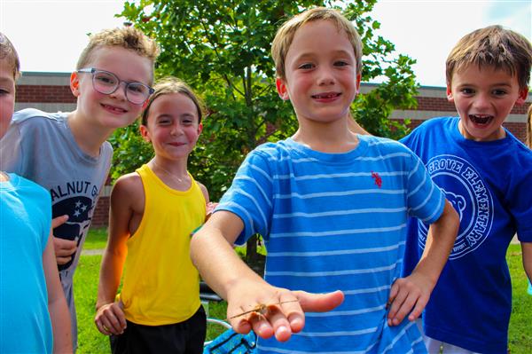 students in a flower garden with butterflies